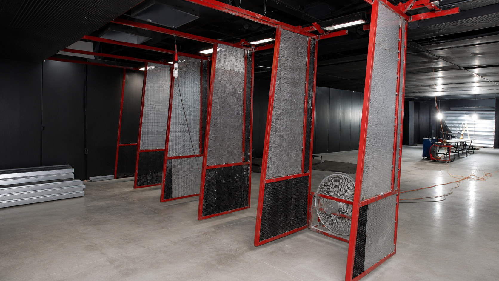 Ballistic panels being installed on an indoor shooting range structure