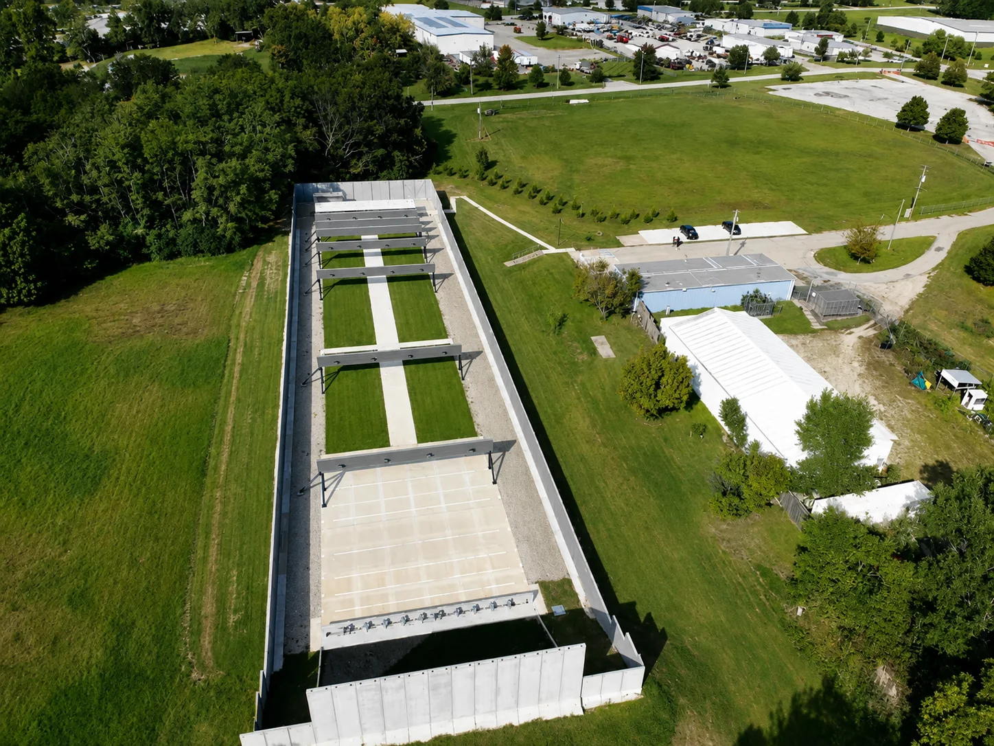 Aerial view of a purpose-built outdoor shooting range with covered firing lines